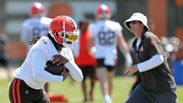 Browns running back D'Onta Foreman runs as offensive coordinator Ken Dorsey watches during minicamp, Wednesday, June 12, 2024, in Berea.