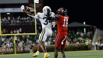 Nov 15, 2025; Waco, Texas, USA; Baylor Bears wide receiver Josh Cameron (34) makes a catch against Utah Utes cornerback Blake Cotton (16) during the second half at McLane Stadium. Mandatory Credit: Chris Jones-Imagn Images