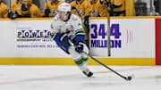 Oct 23, 2025; Nashville, Tennessee, USA;  Vancouver Canucks defenseman Quinn Hughes (43) skates with the puck against the Nashville Predators during the first period at Bridgestone Arena. Mandatory Credit: Steve Roberts-Imagn Images