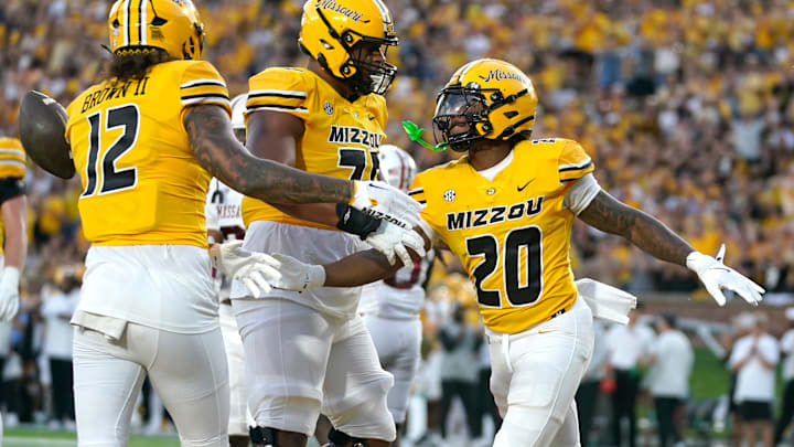 Three Missouri Tigers offensive players celebrate after a touchdown, in a game versus the South Carolina Gamecocks this season.