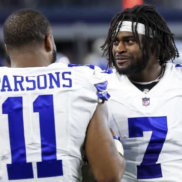 Sep 27, 2021; Arlington, Texas, USA;  Dallas Cowboys linebacker Micah Parsons (11) and cornerback Trevon Diggs (7) laugh during the game against the Philadelphia Eagles at AT&T Stadium. 