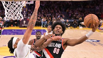 Dec 8, 2024; Los Angeles, California, USA; Los Angeles Lakers forward Anthony Davis (3) defends a shot by Portland Trail Blazers guard Scoot Henderson (00) in the first half at Crypto.com Arena. Mandatory Credit: Jayne Kamin-Oncea-Imagn Images