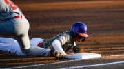 Georgia freshman Charlie Condon (24) attempts to tag out Clemson freshman Nathan Hall (22) at first base during a game at Doug Kingsmore Stadium in Clemson Tuesday, April 18, 2023.