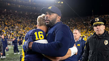 Michigan head coach Sherrone Moore hugs quarterback Davis Warren (16) after 24-17 win over Michigan State at Michigan Stadium in Ann Arbor on Saturday, Oct. 26, 2024.