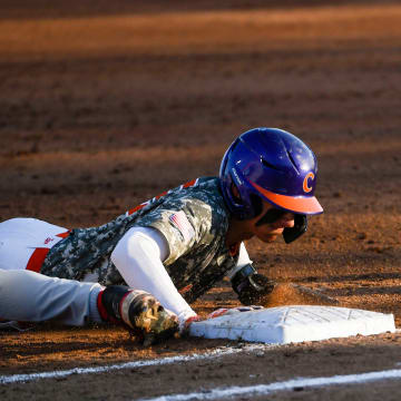 Georgia freshman Charlie Condon (24) attempts to tag out Clemson freshman Nathan Hall (22) at first base during a game at Doug Kingsmore Stadium in Clemson Tuesday, April 18, 2023.