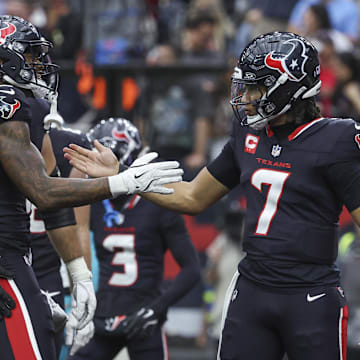 Dec 15, 2024; Houston, Texas, USA; Houston Texans wide receiver Nico Collins (12) celebrates with quarterback C.J. Stroud (7) after a touchdown reception during the second quarter against the Miami Dolphins at NRG Stadium. Mandatory Credit: Troy Taormina-Imagn Images