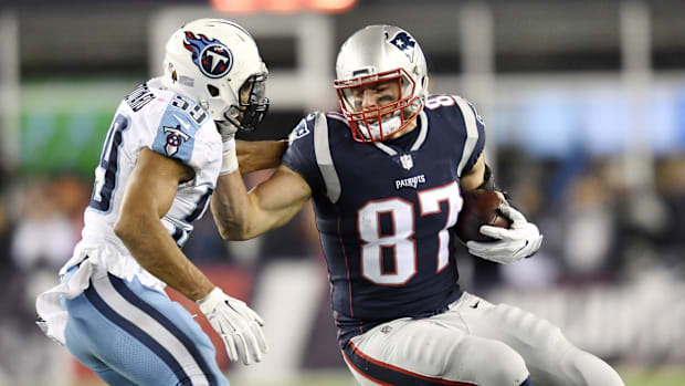 New England Patriots tight end Rob Gronkowski (87) attempts to push off Tennessee Titans linebacker Wesley Woodyard (59) afte