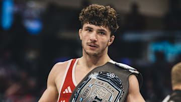 Nebraska's 149 wrestler Ridge Lovett poses with a championship belt after earning his second straight Big Ten title.