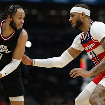 Jan 31, 2024; Washington, District of Columbia, USA; LA Clippers guard Amir Coffey (7) holds the ball as Washington Wizards center Daniel Gafford (21) defends in the second half at Capital One Arena. Mandatory Credit: Geoff Burke-Imagn Images