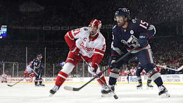 Blue Jackets defenseman Dante Fabbro works against Red Wings center Dylan Larkin at the Ohio Stadium. 