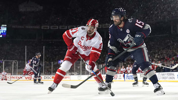 Blue Jackets defenseman Dante Fabbro works against Red Wings center Dylan Larkin at the Ohio Stadium. 