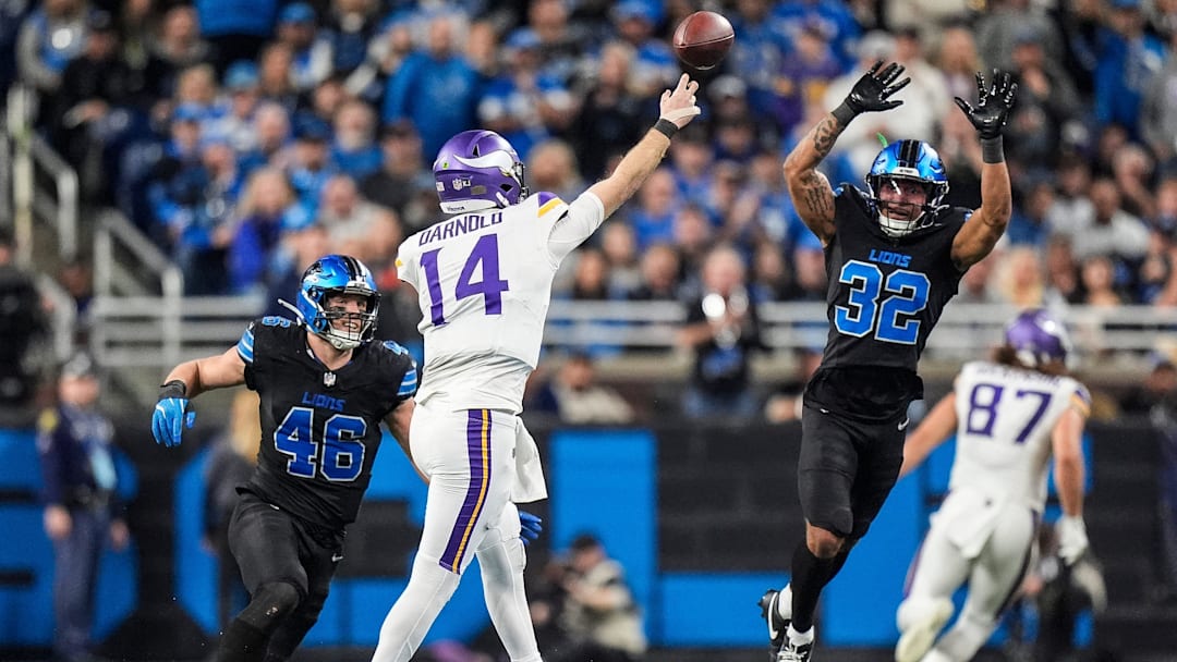Detroit Lions linebacker Jack Campbell (46), left, and safety Brian Branch (32) pressure Minnesota Vikings quarterback Sam Darnold (14) during the second half at Ford Field in Detroit on Sunday, Jan. 5, 2025.