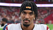 Sep 29, 2024; Glendale, Arizona, USA;  Washington Commanders quarterback Jayden Daniels (5) looks on after beating the Arizona Cardinals at State Farm Stadium. Mandatory Credit: Matt Kartozian-Imagn Images