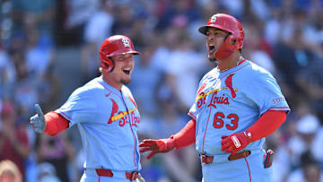 Jul 5, 2025; Chicago, Illinois, USA; St. Louis Cardinals pinch hitter Yohel Pozo (63) celebrates with designated hitter Nolan Gorman (16) after hitting a three-run home run during the eighth inning against the Chicago Cubs at Wrigley Field. Mandatory Credit: Patrick Gorski-Imagn Images