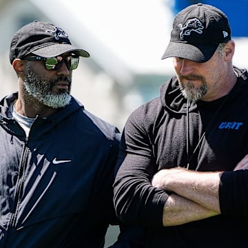 Detroit Lions general manager Brad Holmes, left, talks to head coach Dan Campbell as they walk off the field after practice 
