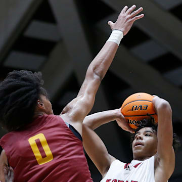 North Oconee's Justin Wise (2) takes a shot while being defended by Holy Innocents Episcopal's Will Hopkins (0) and Holy Innocents Episcopal's Caleb Wilson (24) during the GHSA high school basketball AAAA Region 8 championship game in Macon, Ga., on Wednesday, March 6, 2024. North Oconee won 65-60.