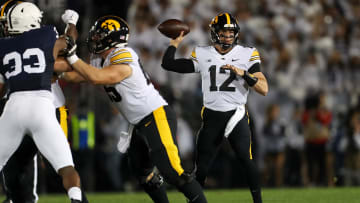 Sep 23, 2023; University Park, Pennsylvania, USA; Iowa Hawkeyes quarterback Cade McNamara (12) looks to throw a pass during the first quarter against the Penn State Nittany Lions at Beaver Stadium. Mandatory Credit: Matthew O'Haren-USA TODAY Sports