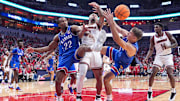 Kansas Jayhawks guard Darryn Peterson (22) and Kansas Jayhawks guard Kohl Rosario (7) surround Louisville Cardinals guard J'Vonne Hadley (1) as the trio battle for a loose ball during an exhibition game at the KFC Yum! Center in Louisville, Kentucky Friday, October 24, 2025.