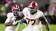 Oct 25, 2025; Columbia, South Carolina, USA; Alabama Crimson Tide offensive lineman Jaeden Roberts (77) blocks for wide receiver Germie Bernard (5) in the second half at Williams-Brice Stadium. Mandatory Credit: Jeff Blake-Imagn Images