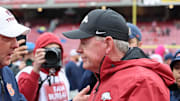Auburn Tigers coach Hugh Freeze shakes hands with Arkansas Razorbacks interim coach Bobby Petrino after the game at Razorback Stadium. Auburn won 33-24.