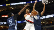 Mar 1, 2024; Memphis, Tennessee, USA; Portland Trail Blazers guard Matisse Thybulle (4) drives to the basket between Memphis Grizzlies guard Vince Williams Jr. (5) and Memphis Grizzlies forward Ziaire Williams (8) during the first half at FedExForum. Mandatory Credit: Petre Thomas-USA TODAY Sports