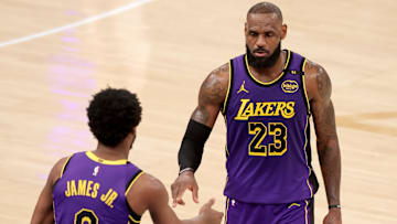 Feb 1, 2025; New York, New York, USA; Los Angeles Lakers guard Bronny James (9) checks in for forward LeBron James (23) during the fourth quarter against the New York Knicks at Madison Square Garden. Mandatory Credit: Brad Penner-Imagn Images