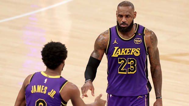 Feb 1, 2025; New York, New York, USA; Los Angeles Lakers guard Bronny James (9) checks in for forward LeBron James (23) durin