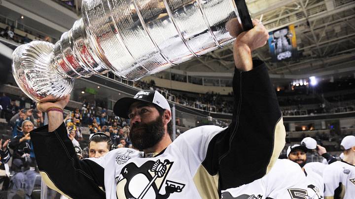 Jun 12, 2016; San Jose, CA, USA; Pittsburgh Penguins player Pascal Dupuis hoists the Stanley Cup after defeating the San Jose Sharks in game six of the 2016 Stanley Cup Final at SAP Center at San Jose. Mandatory Credit: Gary A. Vasquez-Imagn Images