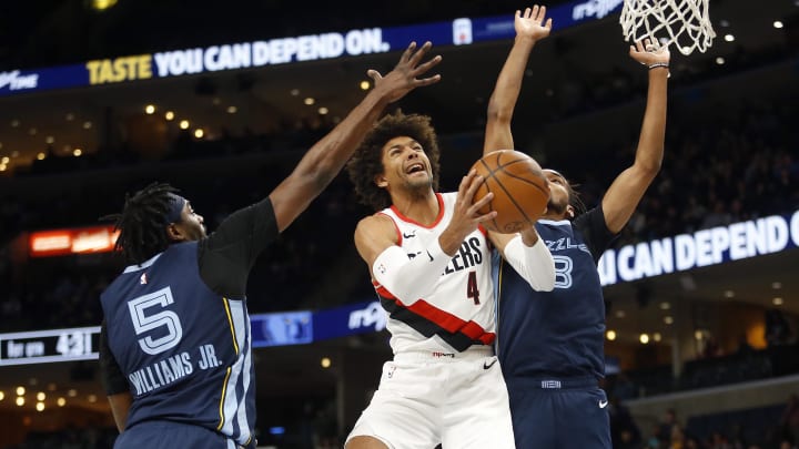 Mar 1, 2024; Memphis, Tennessee, USA; Portland Trail Blazers guard Matisse Thybulle (4) drives to the basket between Memphis Grizzlies guard Vince Williams Jr. (5) and Memphis Grizzlies forward Ziaire Williams (8) during the first half at FedExForum. Mandatory Credit: Petre Thomas-USA TODAY Sports