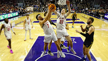 Feb 1, 2025; Evanston, Illinois, USA; Wisconsin Badgers forward Carter Gilmore (7) and forward Steven Crowl (22) grab a rebound against the Northwestern Wildcats during the second half at Welsh-Ryan Arena. Mandatory Credit: David Banks-Imagn Images