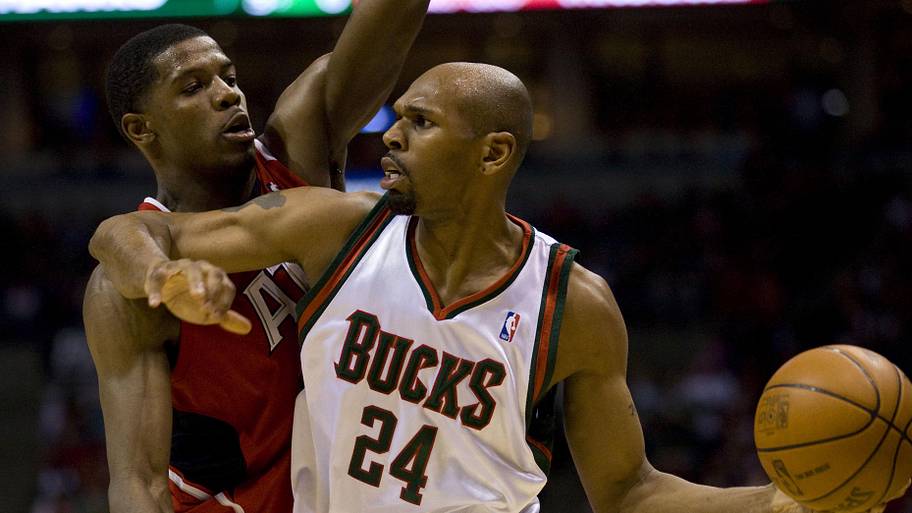 Milwaukee Bucks guard Jerry Stackhouse holds the ball away from Atlanta Hawks guard Joe Johnson.