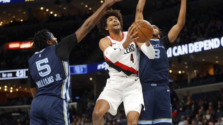 Mar 1, 2024; Memphis, Tennessee, USA; Portland Trail Blazers guard Matisse Thybulle (4) drives to the basket between Memphis Grizzlies guard Vince Williams Jr. (5) and Memphis Grizzlies forward Ziaire Williams (8) during the first half at FedExForum. Mandatory Credit: Petre Thomas-USA TODAY Sports