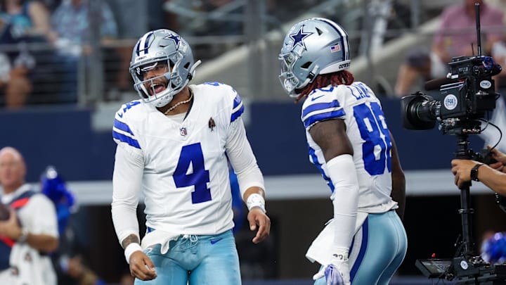 Prescott (4) celebrates with Lamb (88) after a touchdown during the first quarter against the New England Patriots. 