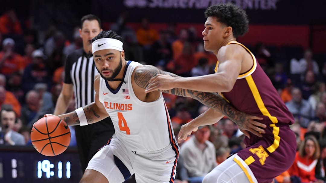Jan 17, 2026; Champaign, Illinois, USA;  Illinois Fighting Illini guard Kylan Boswell (4) drives the ball around Minnesota Golden Gophers guard Isaac Asuma (1) during the first half at State Farm Center. Mandatory Credit: Ron Johnson-Imagn Images
