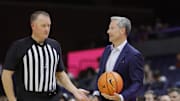 Nov 28, 2025; Charlottesville, Virginia, USA; Virginia Cavaliers head coach Ryan Odom holds the ball on the sidelines against the Queens University of Charlotte Royals during the second half at John Paul Jones Arena. Mandatory Credit: Amber Searls-Imagn Images