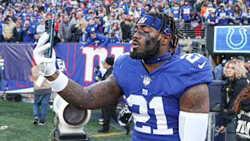 Jan 1, 2023; East Rutherford, New Jersey, USA; New York Giants safety Landon Collins (21) addresses social media on a smart phone after defeating the Indianapolis Colts at MetLife Stadium. Mandatory Credit: Vincent Carchietta-Imagn Images