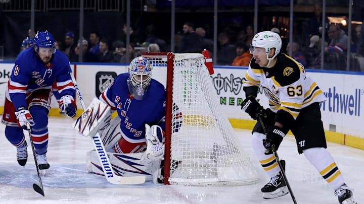 Feb 5, 2025; New York, New York, USA; Boston Bruins left wing Brad Marchand (63) controls the puck against New York Rangers goaltender Igor Shesterkin (31) and left wing J.T. Miller (8) during the first period at Madison Square Garden. Mandatory Credit: Brad Penner-Imagn Images