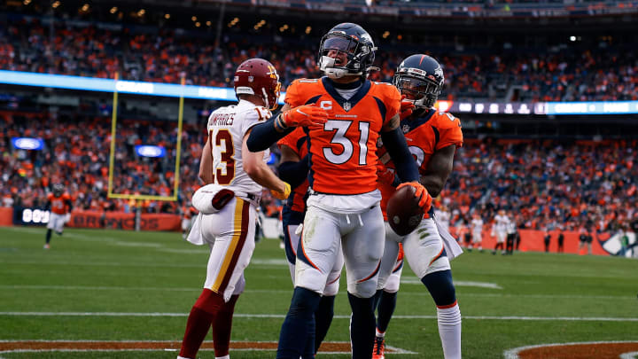 Oct 31, 2021; Denver, Colorado, USA; Denver Broncos safety Justin Simmons (31) celebrates with safety Kareem Jackson (22) after an interception in the second quarter against the Washington Football Team at Empower Field at Mile High. Mandatory Credit: Isaiah J. Downing-USA TODAY Sports