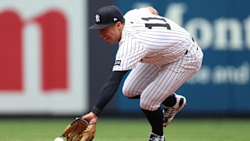 Jun 28, 2025; Bronx, New York, USA; New York Yankees shortstop Anthony Volpe (11) fields a ground ball during the third inning against the Athletics at Yankee Stadium. Mandatory Credit: Vincent Carchietta-Imagn Images