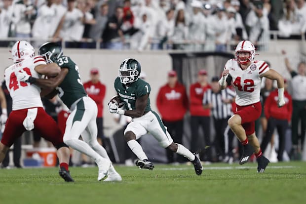 Nick Henrich gives chase as Michigan State's Jayden Reed returns a punt for a fourth-quarter touchdown against Nebraska in 20