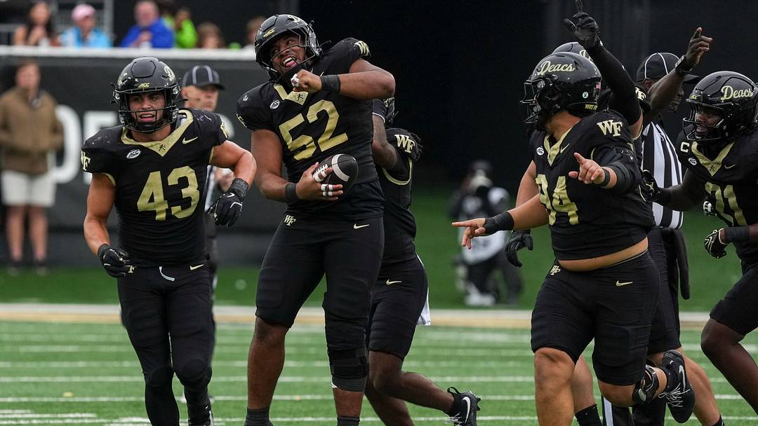 Oct 3, 2026; Winston-Salem, North Carolina, USA; Wake Forest Demon Deacons defensive lineman Dallas Afalava (52) celebrates his interception of Stanford Cardinal quarterback Davis Warren (8) during the second half at Allegacy Federal Credit Union Stadium. Mandatory Credit: Jim Dedmon-Imagn Images Oct 3, 2026; Winston-Salem, North Carolina, USA; Wake Forest Demon Deacons defensive lineman Dallas Afalava (52) celebrates his interception of Stanford Cardinal quarterback Davis Warren (8) during the second half at Allegacy Federal Credit Union Stadium. Mandatory Credit: Jim Dedmon-Imagn Images