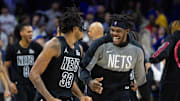 Feb 22, 2025; Philadelphia, Pennsylvania, USA; Brooklyn Nets center Nic Claxton (33) celebrates with center Day'Ron Sharpe after scoring the game winning shot against the Philadelphia 76ers as time expired in the fourth quarter at Wells Fargo Center. Mandatory Credit: Bill Streicher-Imagn Images