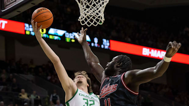 Oregon center Nate Bittle rebounds the ball over Indiana center Oumar Ballo
