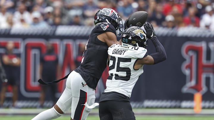 Sep 29, 2024; Houston, Texas, USA; Jacksonville Jaguars cornerback Ronald Darby (25) attempts to break up a pass intended for Houston Texans wide receiver Robert Woods (2) during the fourth quarter at NRG Stadium. Mandatory Credit: Troy Taormina-Imagn Images