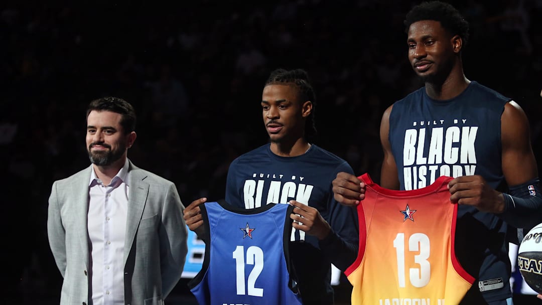 Feb 15, 2023; Memphis, Tennessee, USA; Memphis Grizzlies general manager Zach Kleiman (left) and head coach Taylor Jenkins (right) present guard Ja Morant (12) and forward Jaren Jackson Jr. (13) with their All- Star game jerseys prior to the game against the Utah Jazz at FedExForum. Mandatory Credit: Petre Thomas-Imagn Images