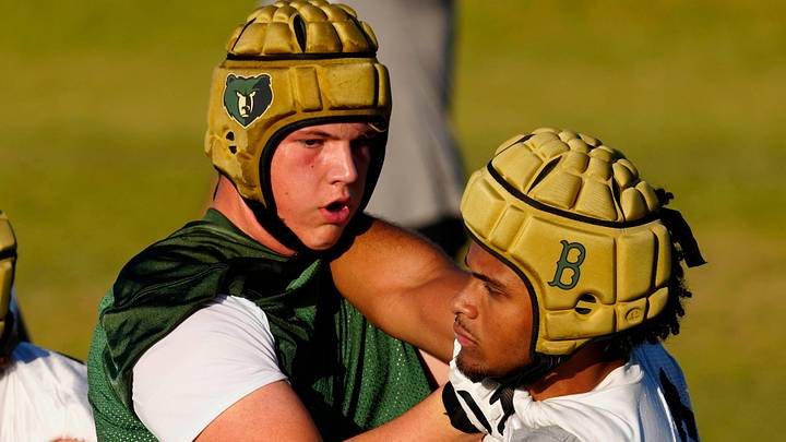 Basha tackle Jake Hildebrand battles edge rusher Darian “Bleu” Dantzler during a practice at Basha High School