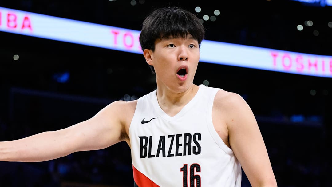 Oct 27, 2025; Los Angeles, California, USA; Portland Trail Blazers center Yang Hansen (16) reacts during the first half against the Los Angeles Lakers at Crypto.com Arena. Mandatory Credit: William Liang-Imagn Images