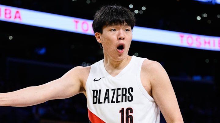 Oct 27, 2025; Los Angeles, California, USA; Portland Trail Blazers center Yang Hansen (16) reacts during the first half against the Los Angeles Lakers at Crypto.com Arena. Mandatory Credit: William Liang-Imagn Images