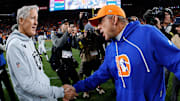 Nov 6, 2025; Denver, Colorado, USA; Denver Broncos head coach Sean Payton greets Las Vegas Raiders head coach Pete Carrolla after the game at Empower Field at Mile High. Mandatory Credit: Isaiah J. Downing-Imagn Images