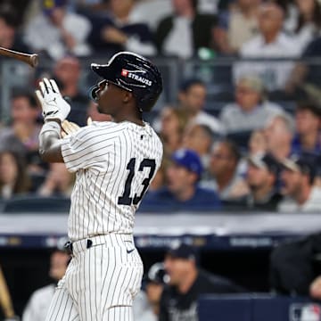 Oct 7, 2025; Bronx, New York, USA; New York Yankees second baseman Jazz Chisholm Jr. (13) hits a solo home run in the fifth inning against the Toronto Blue Jays during game three of the ALDS round for the 2025 MLB playoffs at Yankee Stadium. Mandatory Credit: Vincent Carchietta-Imagn Images